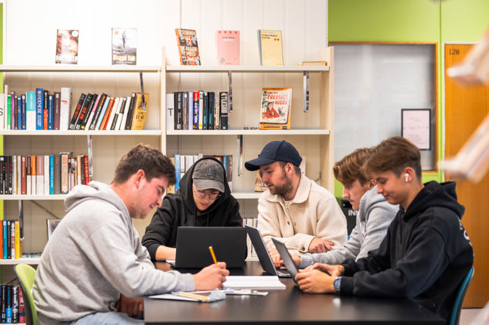 Elevar sitt saman rundt eit bord på biblioteket